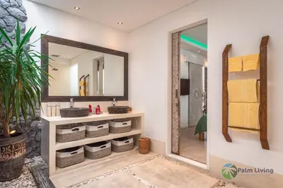 a bathroom with a sink and a mirror at Villa Babar in Canggu