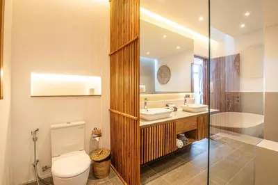 a bathroom with a toilet and a sink and a shower at Elegant 5BR Tropical Escape Just 400m to Beach in Canggu