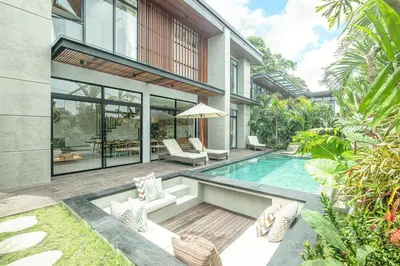 an exterior view of a house with a swimming pool at Elegant 5BR Modern Villa Steps from Café Del Mar in Canggu