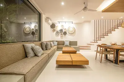 a living room with a couch and a table at Elegant 5BR Modern Villa Steps from Café Del Mar in Canggu