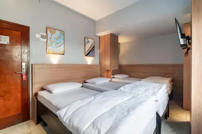 a row of beds in a room at Hotel Dakozi Living in Kuta