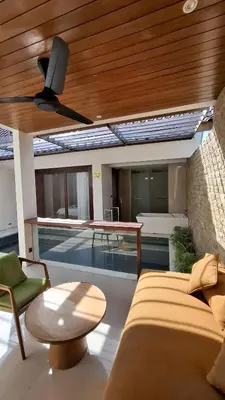 a living room with a couch and a ceiling fan at NOWACs SASADARA in Canggu