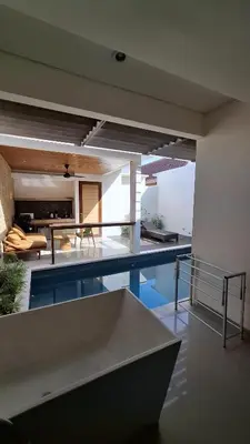 a house with a swimming pool and a living room at NOWACs SASADARA in Canggu