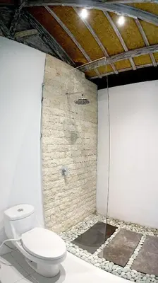 a bathroom with a toilet and a walk in shower at PROMO Private Vacation Rental Villa 2 Pools 4 Bedrooms 4 Bathroom Free Airport Pickup in Denpasar