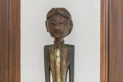 a wooden statue of a woman in front of a wall at Villa Sedap Malam Seminyak by Best Deals Asia Hospitality in Seminyak
