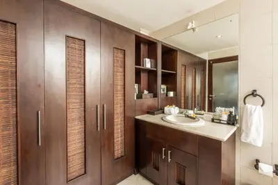 a bathroom with a sink and wooden cabinets at Villa Sedap Malam Seminyak by Best Deals Asia Hospitality in Seminyak