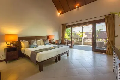 a bedroom with a large bed and a large window at Villa Sedap Malam Seminyak by Best Deals Asia Hospitality in Seminyak