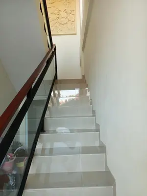 a stairway with a glass railing and a stair case at Erick house in Seminyak