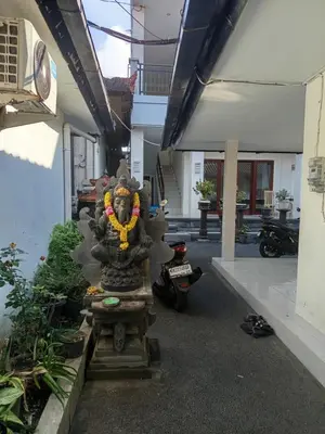 a stone statue in the middle of a building at Erick house in Seminyak