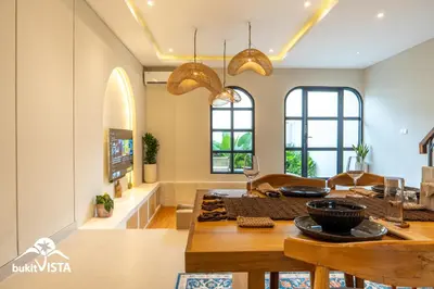 a dining room and living room with a table at Serayu Berawa by Bukit Vista in Canggu