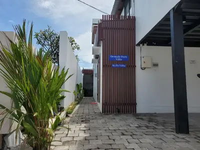 a sign on the side of a building at Oemah Ozzy Villa 2 Bedroom With Privat Pool in Seminyak