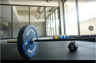 a barbell on the floor of a gym at Ambengan Tenten By BMI in Denpasar