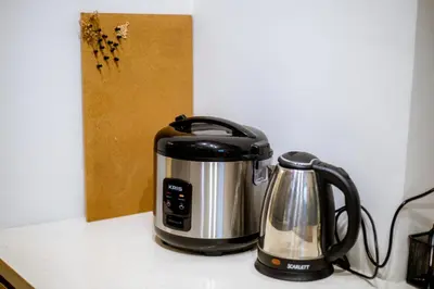 a coffee maker and a tea kettle on a counter at Jemma Home Warm & Simple 3BR Stay in Denpasar near Sanur in Pesanggaran