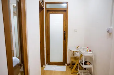 a room with a door and a table and a mirror at Jemma Home Warm & Simple 3BR Stay in Denpasar near Sanur in Pesanggaran