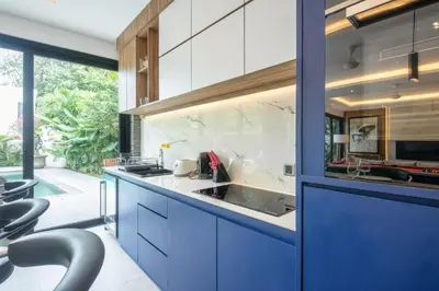 a kitchen with blue cabinets and a sink at Luxury 3BR Modern Villa in the Heart of Seminyak in Seminyak