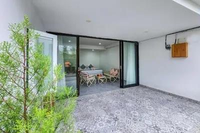 an external view of a house with a patio at Emilia 1 Bedroom Apartment Seminyak by Nagisa Bali in Kerobokan