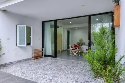 a room with sliding glass doors and a patio at Emilia 1 Bedroom Apartment Seminyak by Nagisa Bali in Kerobokan