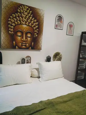 a bedroom with a large picture of a headboard at Amshiga 2 in Jimbaran