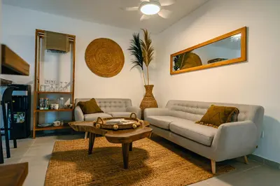 a living room with a couch and a table at Amshiga 6 in Jimbaran