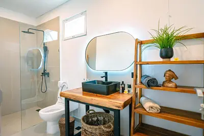 a bathroom with a sink and a mirror at Amshiga 6 in Jimbaran