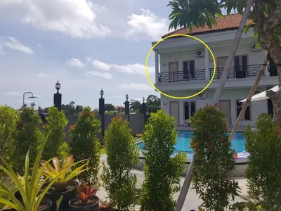 a picture of a building with a window and plants at Studio with rice field view in Kerobokan in Kerobokan