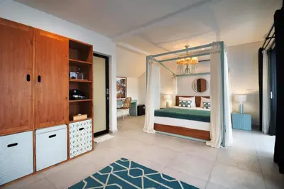 a bedroom with a bed with a canopy at Berawa Nest by CPM Bali in Canggu