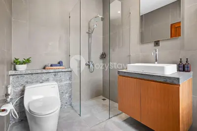 a bathroom with a shower and a toilet and a sink at deTasia Villa by Kozystay - Jimbaran in Jimbaran