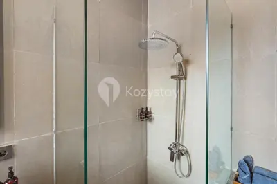 a shower with a glass door in a bathroom at Gracia Villa by Kozystay - Jimbaran in Jimbaran