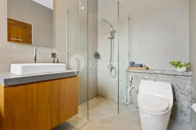 a bathroom with a toilet and a sink and a shower at Gracia Villa by Kozystay - Jimbaran in Jimbaran