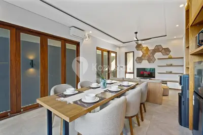 a dining room and living room with a table and chairs at Gracia Villa by Kozystay - Jimbaran in Jimbaran