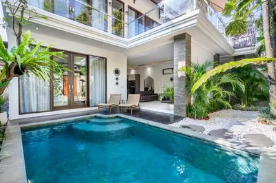 a swimming pool in the middle of a house at Villa Naga by JB Villas in Seminyak