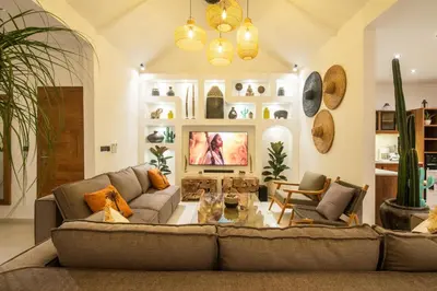 a living room with a couch and a tv at Villa ADDI 4bedrooms Oberoi in Seminyak