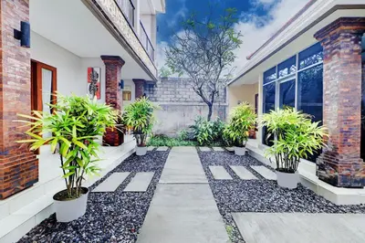 a courtyard with potted plants in front of a building at Collection O Bali Sanur near Bali Mandara Hospital in Sanur