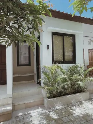 a house with some plants in front of it at Sukanadi's Homestay in Legian