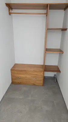 a closet with wooden shelves and a white wall at Sunflower Bali Villa 3BR Legian Double Six Beach in Seminyak