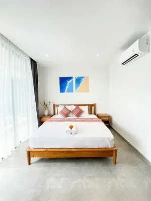 a bedroom with a large bed with white sheets at Sunflower Bali Villa 3BR Legian Double Six Beach in Seminyak
