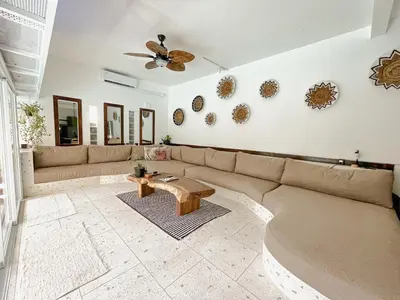 a living room with a couch and a table at Villa Vela in the heart of Seminyak in Seminyak