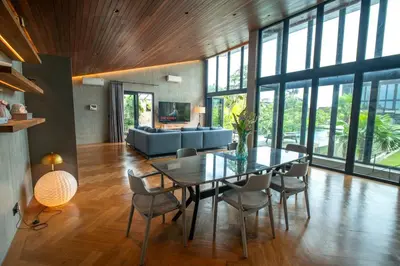 a dining room with a glass table and chairs at Lillypad 5Bed Villa in Seminyak