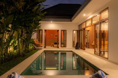 an infinity pool in the backyard of a villa at Villa Suka Damai Peaceful 2 Bedroom Getaway in Seminyak