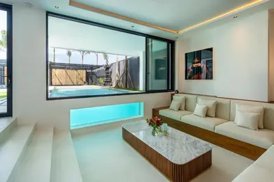 a living room with a couch and a table at House of Light 5bed villa in Canggu