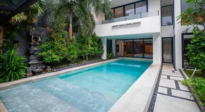 a swimming pool in front of a house at House of Light 5bed villa in Canggu