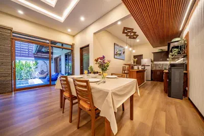 a kitchen and dining room with a table and chairs at Seminyak Happy Villa in Legian