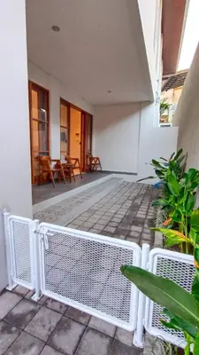 a patio with chairs and tables in a building at AA Inn Kuta Beach in Ngurah Rai International Airport