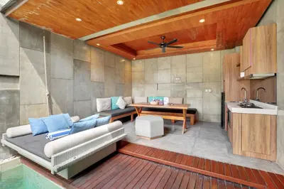 a living room with a couch and a table and a sink at Aqilah Villa Bali in Legian