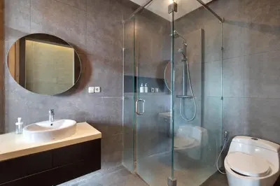 a bathroom with a shower and a toilet and a sink at Aqilah Villa Bali in Legian