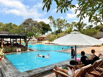 a group of people in a pool at a resort at Apartment at Jayakarta Residence Beach Front Access in Seminyak