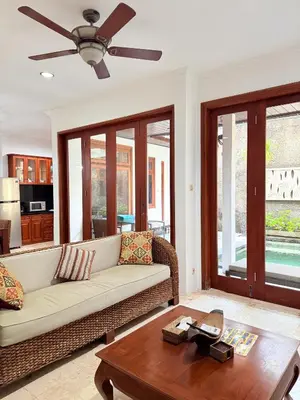 a living room with a couch and a table at Villa Mimi Mesari Kuta Bali in Kuta