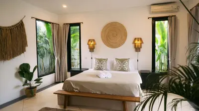 a bedroom with a bed with two towels on it at Splendid 3 BR villa with large pool and garden in Canggu
