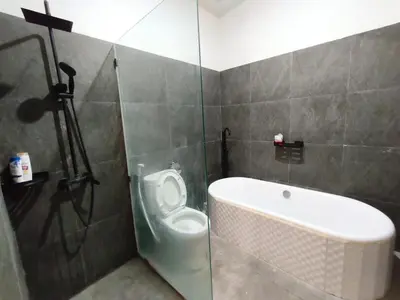 a bathroom with a toilet and a bath tub at Villa Videl in Seminyak