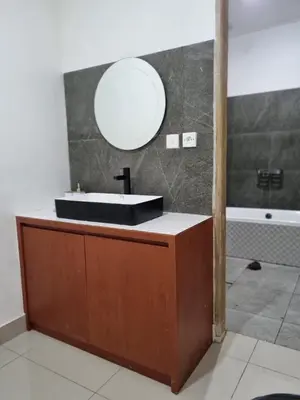 a bathroom with a black sink and a mirror at Villa Videl in Seminyak